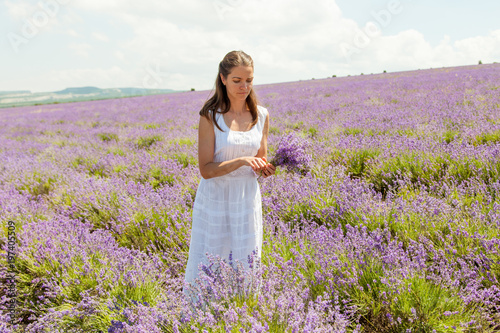 Fototapeta Naklejka Na Ścianę i Meble -  The girl collects lavender