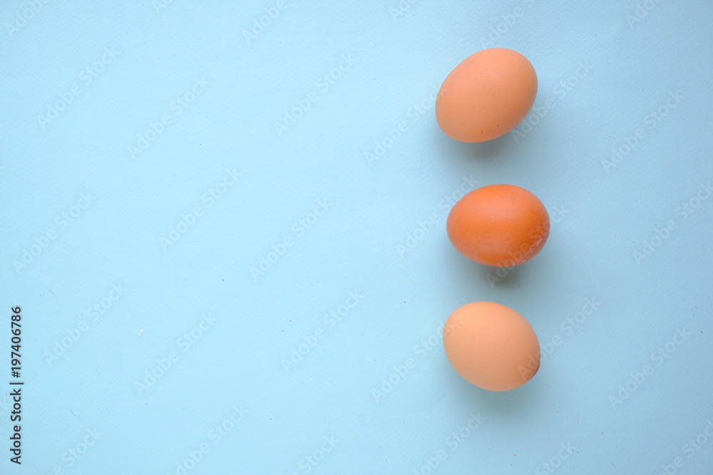 Eggs on blue background top view