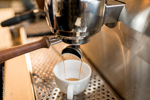 Close-up view on the professional coffee machine making espresso