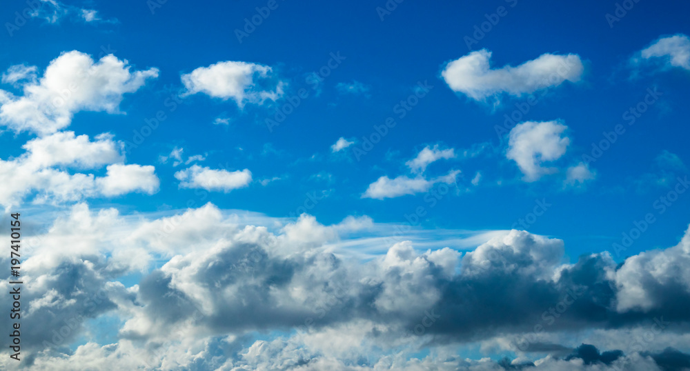 Obraz premium Blue cumulus clouds in the clear summer sky.