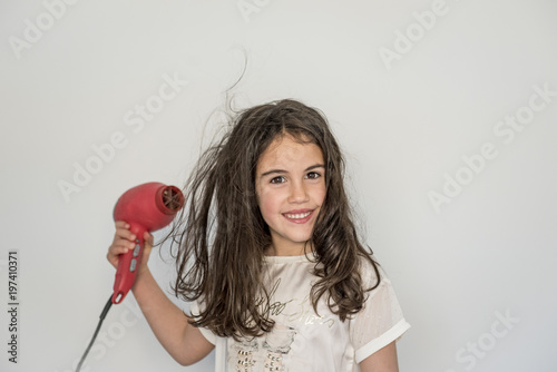 little girl posing and drying her hair