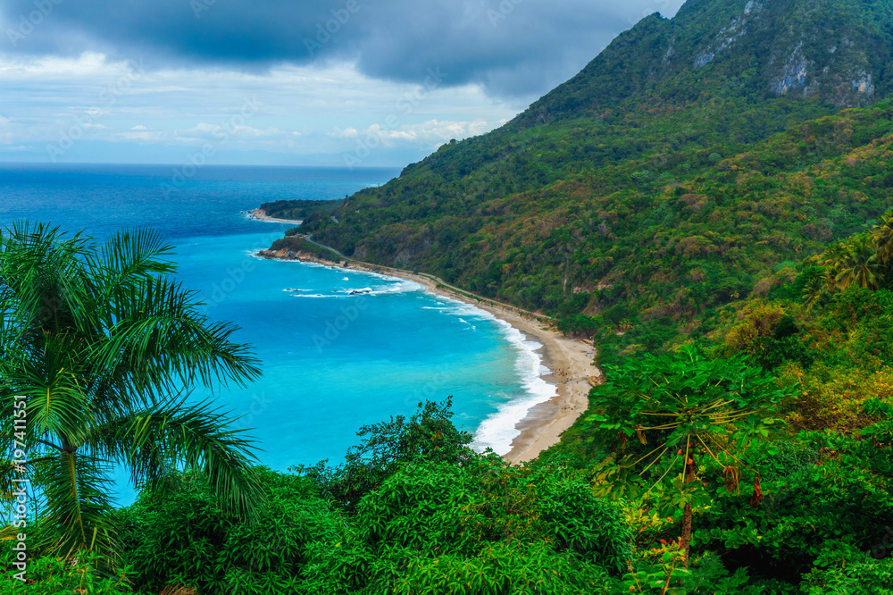 juicy natural wild landscape with rocky mountains overgrown dense green jungle tree, palm and clear azure water of sea ocean juicy natural wild landscape with rocky mountains overgrown dense green jungle tree, palm and clear azure water of sea ocean