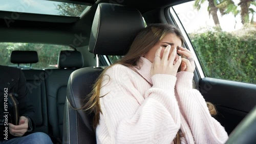 Woman crying after being robbed by criminal in car