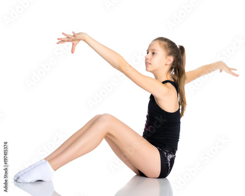 The gymnast perform an acrobatic element on the floor. © lotosfoto