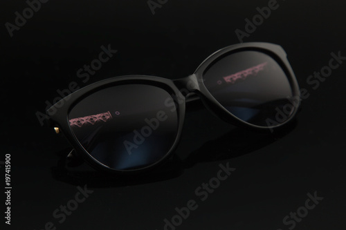 Fashion women sunglasses, black plastic, gold decoration on the douche, stylish gradient with polarizing filter.