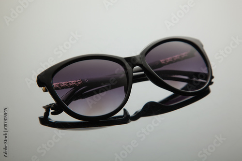 Fashion women sunglasses, black plastic, gold decoration on the douche, stylish gradient with polarizing filter.