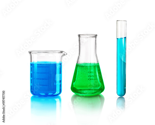 laboratory glassware with multi-colored liquid inside isolated on a white background photo