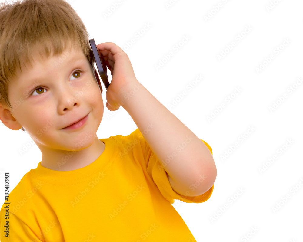 A little boy communicates on a mobile phone. A little boy communicates on a mobile phone.