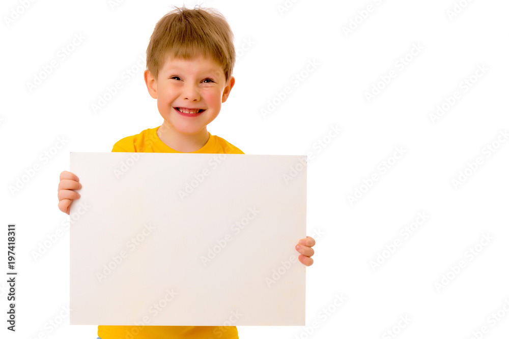 A little boy is looking from behind an empty banner. A little boy is looking from behind an empty banner.