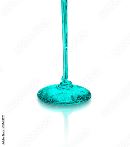 emerald liquid that pours on the glass surface
