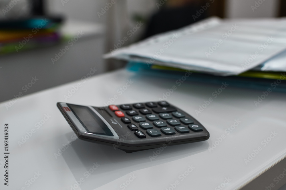 Closeup on calculator over light desk background. Top side view flat lay style of digital compute technology idea Closeup on calculator over light desk background. Top side view flat lay style of digital compute technology idea