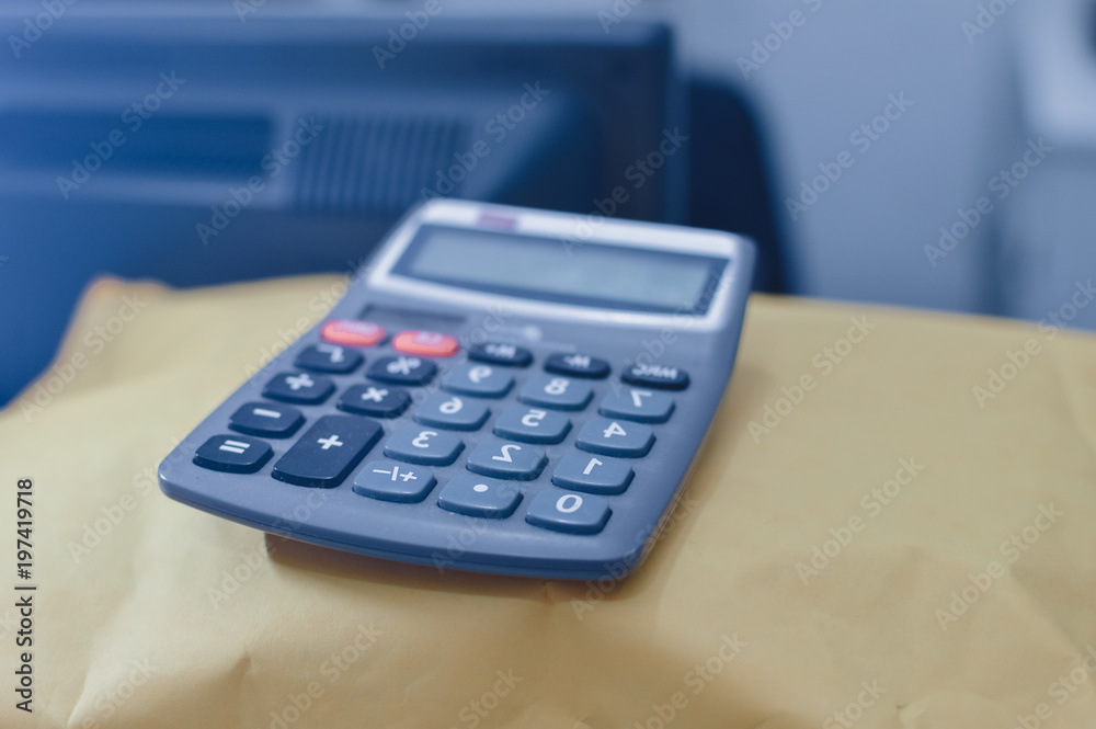 Closeup on calculator over light desk background. Top side view flat lay style of digital compute technology idea Closeup on calculator over light desk background. Top side view flat lay style of digital compute technology idea