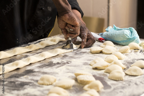 black chef cutting ravioli