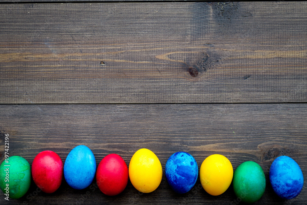 Colorful easter eggs on wooden background top view mock-up Colorful easter eggs on wooden background top view mock-up