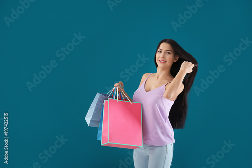Happy young woman with shop...