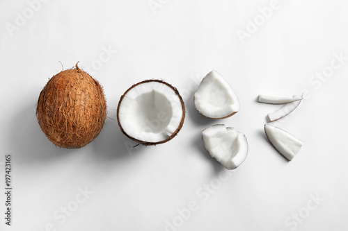 Fototapeta Pieces of coconut on white background, flat lay