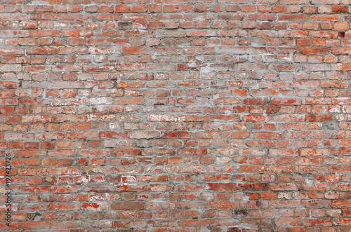 An ancient motley red brick wall