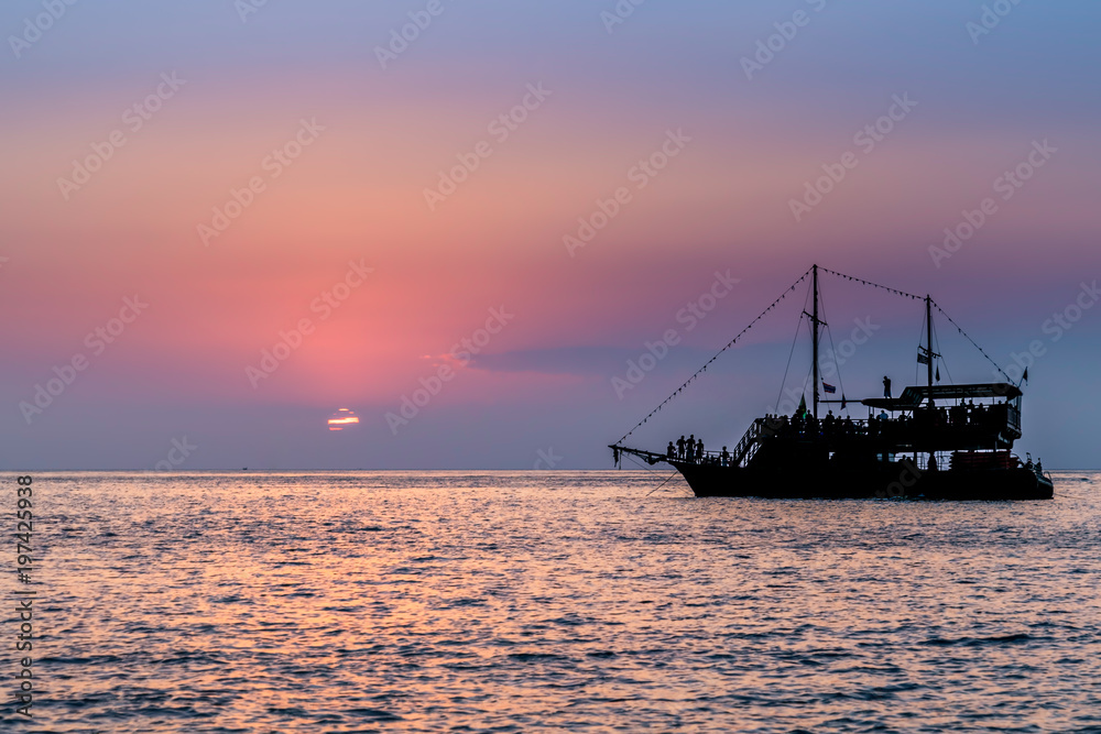 Pirate ship in the ocean during sunset