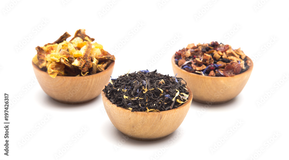 Loose Leaf Tea in a Wooden Bowls on a White Background Loose Leaf Tea in a Wooden Bowls on a White Background