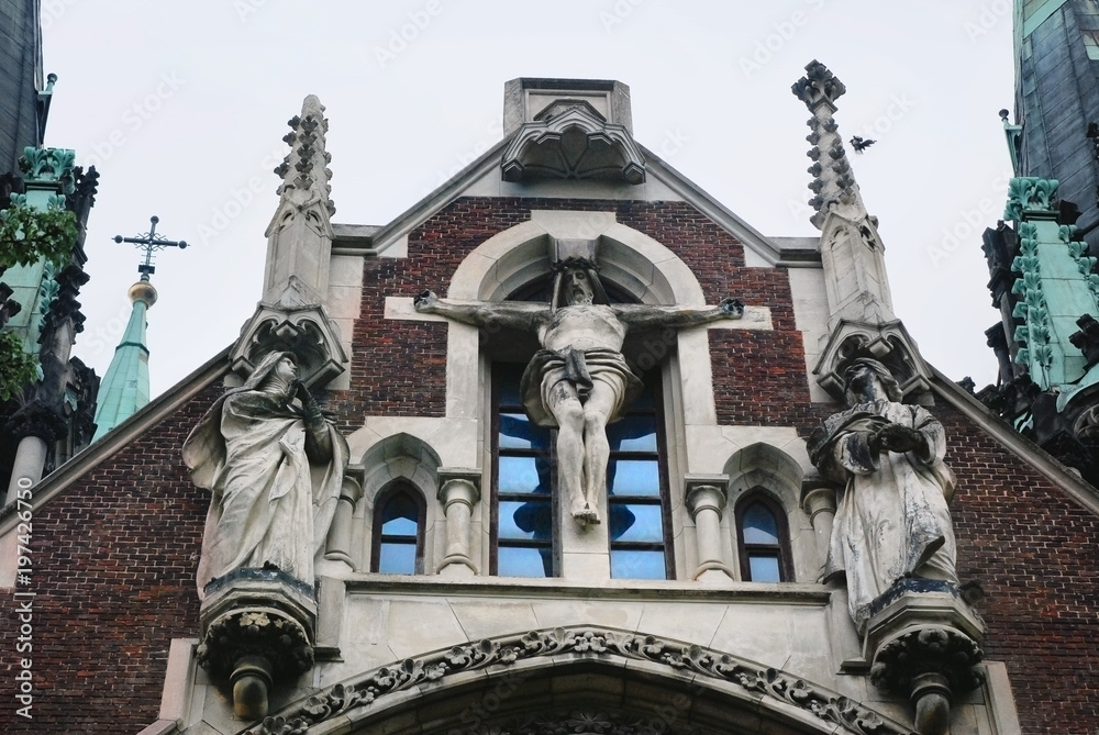 Baroque and Gothic architecture. Crucifixion of Jesus on facade of the building. St. Olga and Elizabeth church in Lviv. Baroque and Gothic architecture. Crucifixion of Jesus on facade of the building. St. Olga and Elizabeth church in Lviv.