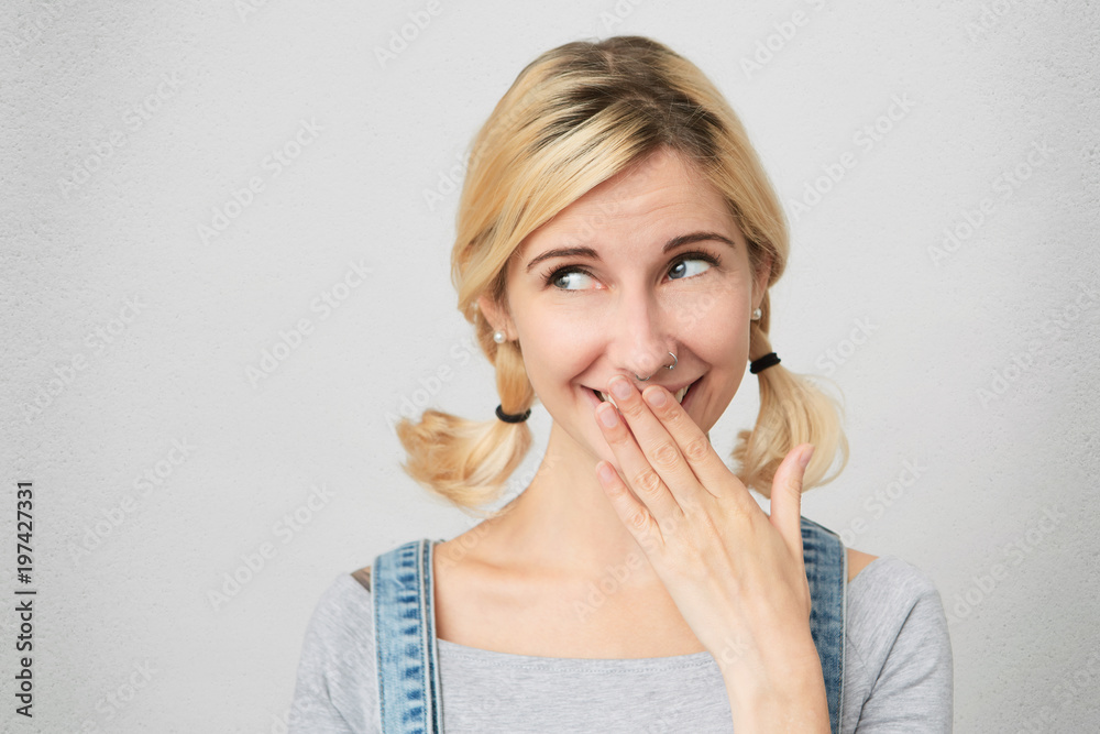 You are so funny! Young girl wears ovveralls looking aside and flirting with boyfriend. Close her mouth with palm. Isolated with copy space You are so funny! Young girl wears ovveralls looking aside and flirting with boyfriend. Close her mouth with palm. Isolated with copy space