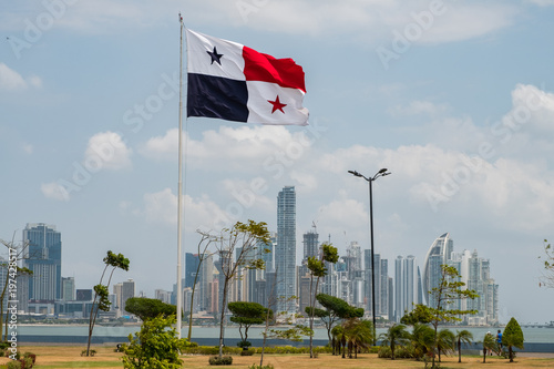 National flag of Panama with skyline of Panama City in background