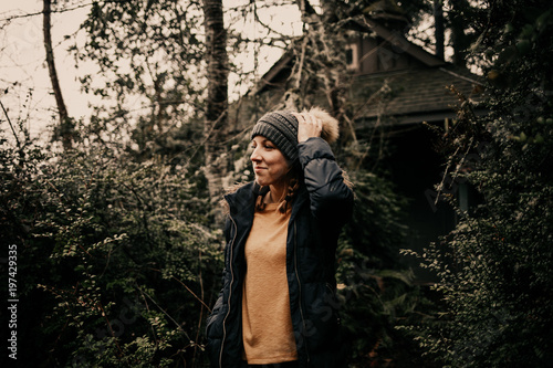 Girl wearing winter fashion at forest cabin 