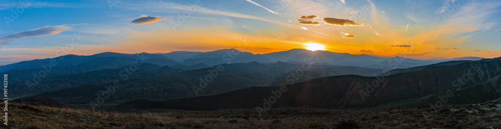 Colorful bright sunset in the mountains, panoramic photo
