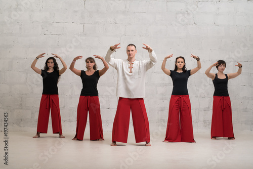Group yoga training shot against brick wall photo