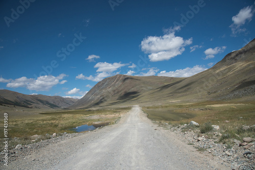 Wildlife Altai. The road, mountains and sky with clouds in summer