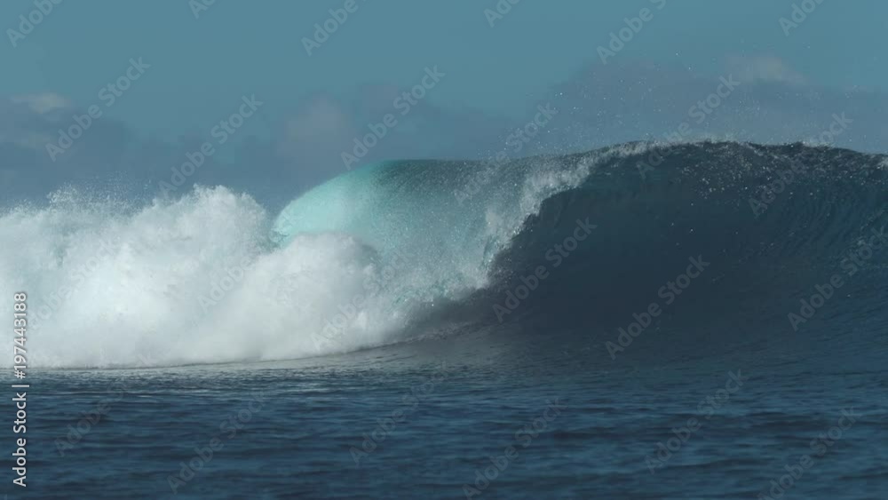 SLOW MOTION: Beautiful sparkling ocean wave crashes and sends water drops flying far around the sunlit beach. Powerful deep blue swell glistens in the sun as it curls down and approaches exotic shore. SLOW MOTION: Beautiful sparkling ocean wave crashes and sends water drops flying far around the sunlit beach. Powerful deep blue swell glistens in the sun as it curls down and approaches exotic shore.