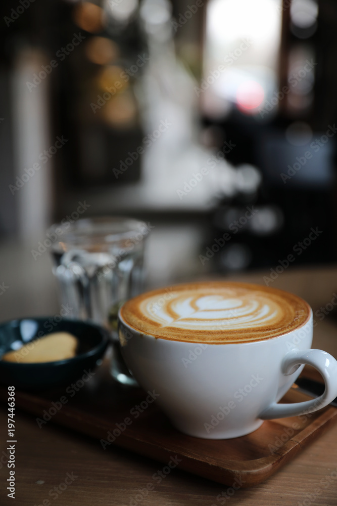 Cappuccino coffee cup on wood background