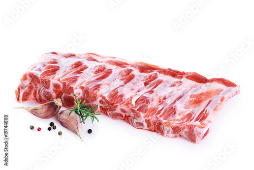 Raw fresh pork ribs, garlic, pepper and rosemary isolated on white background.