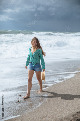 happy woman walking on the beach
