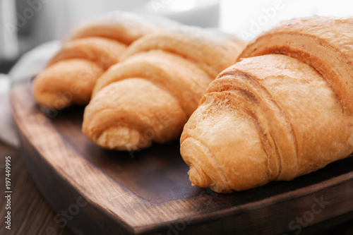Tasty croissants on wooden tray, closeup © Africa Studio
