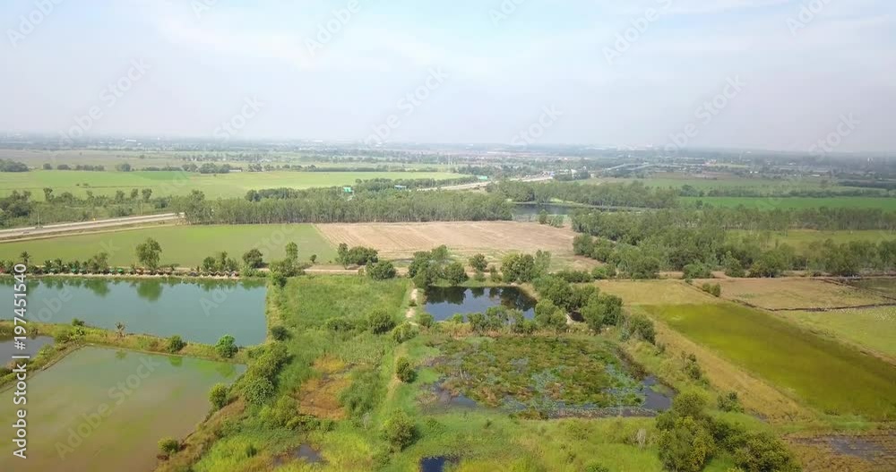 Aerial View, Flying over the rice field and highway with beautiful Landscape nature with aerial camera shot, Thailand. Aerial View, Flying over the rice field and highway with beautiful Landscape nature with aerial camera shot, Thailand.