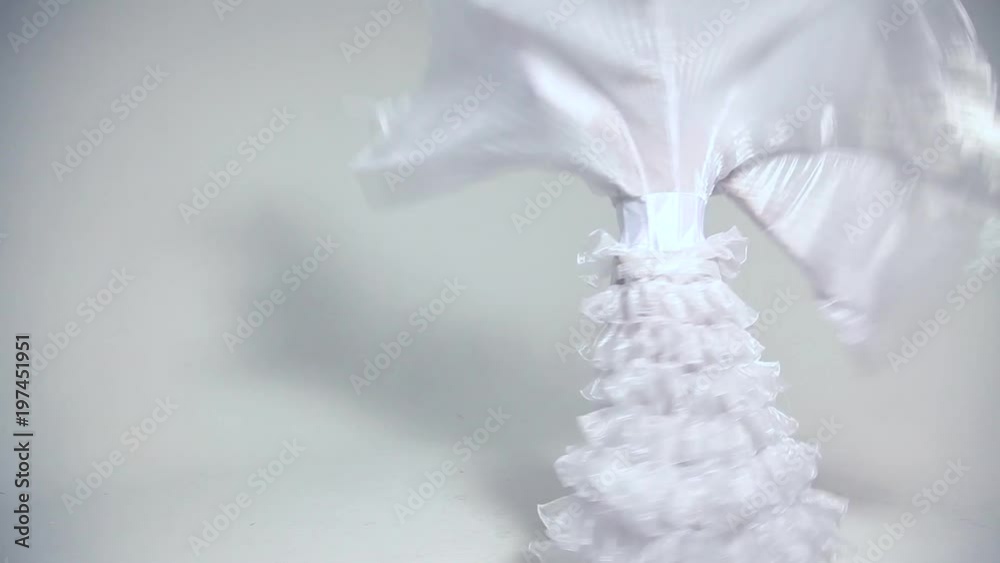 Young beautiful woman dancing in white costume Young beautiful woman dancing in white costume