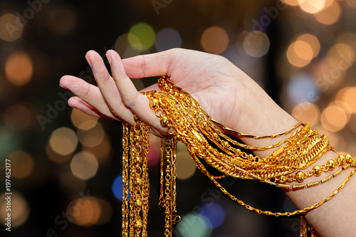 Beautiful woman hand hold gold necklace jewelry, Accessory and fashion.