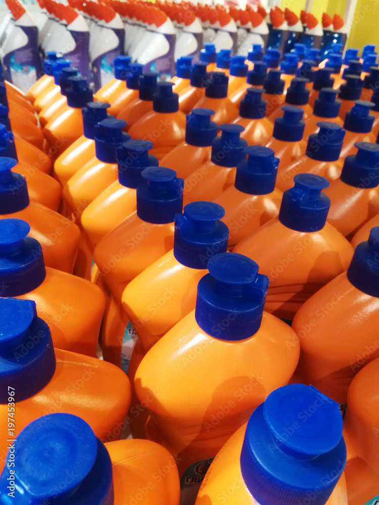 Orange bottles with detergent in the shop Orange bottles with detergent in the shop