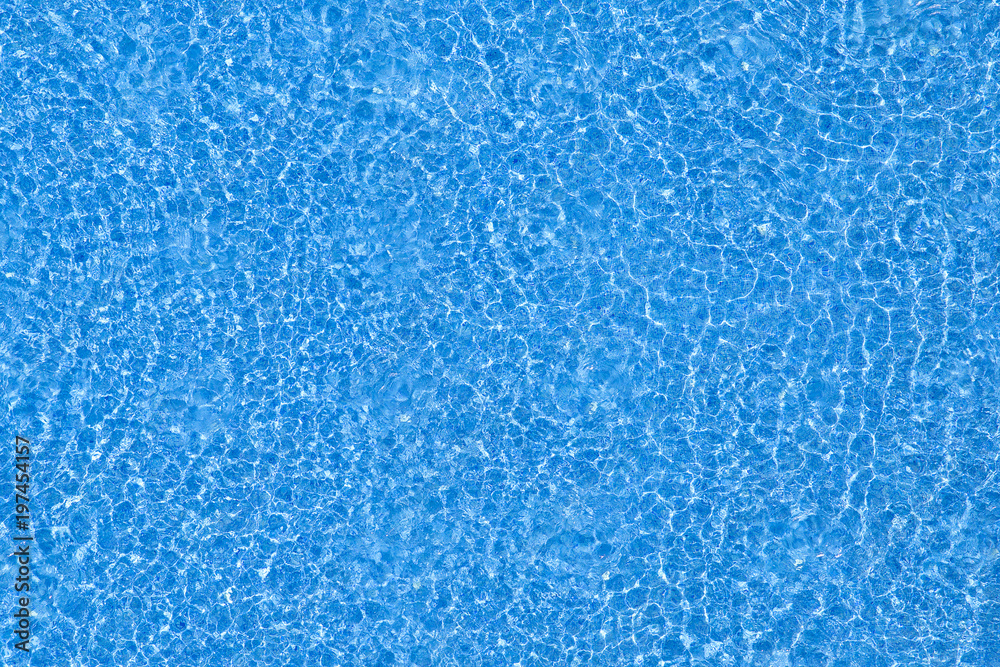 Water ripples texture on blue swimming pool background. Top view
