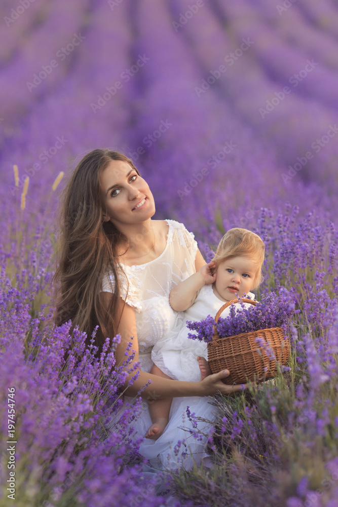 Happy beautiful mother and cute little daughter have fun in aroma lavender fields. Family holiday in summer day. Happy beautiful mother and cute little daughter have fun in aroma lavender fields. Family holiday in summer day.