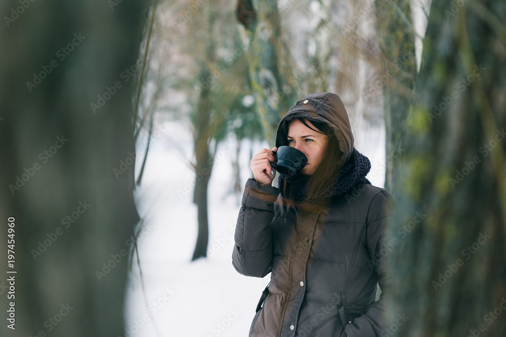 Woman winter clothing drinking coffee snowy forest Woman winter clothing drinking coffee snowy forest