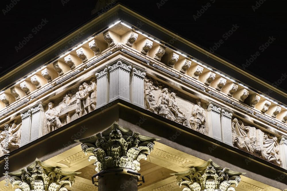 Part of a beautiful building with columns and night lights Part of a beautiful building with columns and night lights