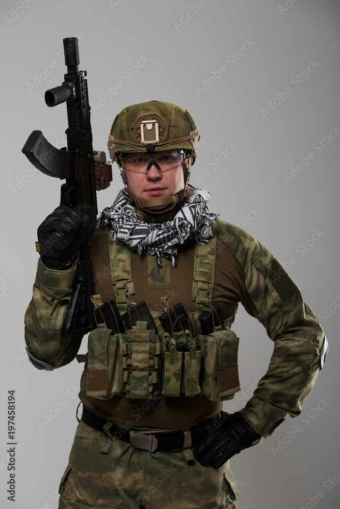 Fototapeta premium Picture soldier in goggles with gun in his hand