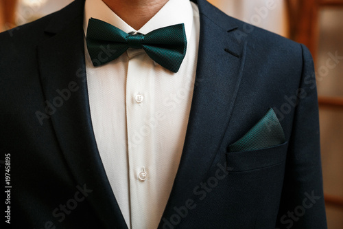 Groom black suit with a bow tie