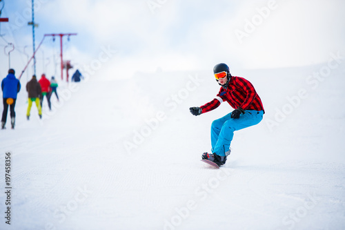 Photo of athlete with snowboard jumping on snowy hill