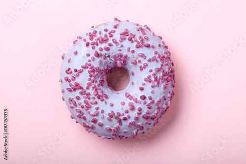 Sweet glazed raspbrery donut on pink background