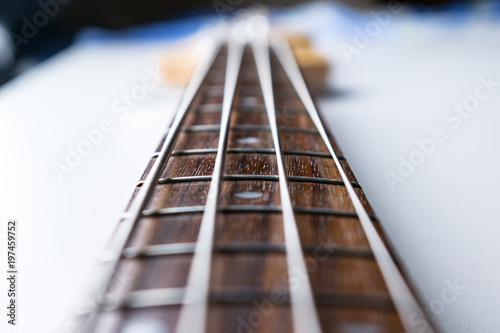 Frets on bass guitar. Close up. Vintage old retro bass in studio