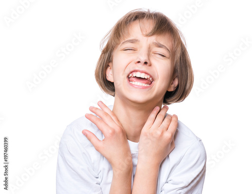 Portrait of sad attractive caucasian girl, isolated on white background. Unhappy or frustrated and angry schoolgirl screaming. Child in white t-shirt - emotional portrait close-up. photo