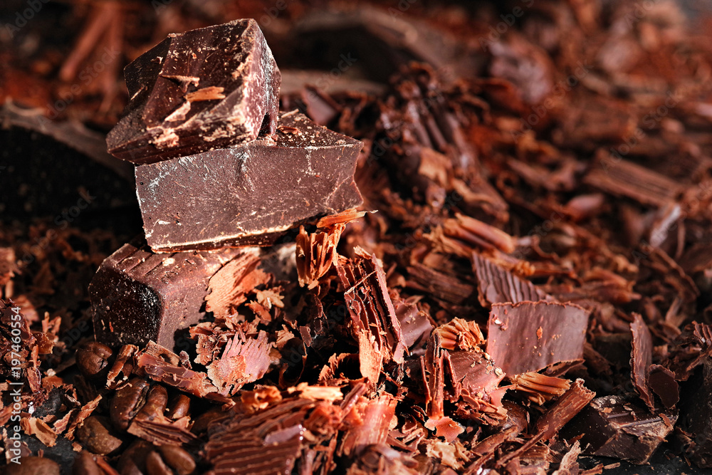 Broken dark chocolate, cocoa powder and coffee beans on a wooden table Broken dark chocolate, cocoa powder and coffee beans on a wooden table